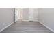 This bedroom has gray walls, gray vinyl floors, and multiple doors at 1703 Laurel Creek Cir, Lithonia, GA 30058