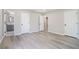 This bedroom has gray walls, gray vinyl floors, and three white doors at 1703 Laurel Creek Cir, Lithonia, GA 30058