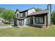 Beautiful two-story home featuring white siding, black trim, shutters, a well-kept lawn, and a driveway at 1703 Laurel Creek Cir, Lithonia, GA 30058