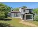 Exterior of home featuring large backyard and sunroom addition at 1703 Laurel Creek Cir, Lithonia, GA 30058