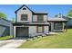 Charming two-story home with a manicured lawn, black trim, wood shutters, and attached garage in a suburban neighborhood at 1703 Laurel Creek Cir, Lithonia, GA 30058