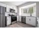 Modern kitchen featuring white cabinets, stainless steel appliances, and new countertops at 1703 Laurel Creek Cir, Lithonia, GA 30058