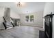 Open-concept living room featuring neutral-toned walls, vinyl floors, a black fireplace, and staircase at 1703 Laurel Creek Cir, Lithonia, GA 30058