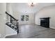 Spacious living room showcasing neutral-toned walls, modern vinyl floors, and a black fireplace at 1703 Laurel Creek Cir, Lithonia, GA 30058