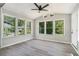 Bright sunroom with many windows letting in natural light and a ceiling fan at 1703 Laurel Creek Cir, Lithonia, GA 30058
