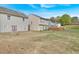 Large backyard with a lawn area, fence, and the rear of multiple homes, perfect for outdoor activities at 200 Arrowhead Ln, Canton, GA 30114