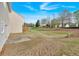Expansive backyard featuring green grass, mature trees, and the rear of the house with a patio at 200 Arrowhead Ln, Canton, GA 30114