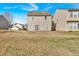 Spacious backyard with grass and the back of the house, offering potential for recreation and relaxation at 200 Arrowhead Ln, Canton, GA 30114