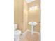 Small half bathroom features a pedestal sink, white walls, and a toilet at 200 Arrowhead Ln, Canton, GA 30114