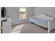 Cozy bedroom with a twin bed, neutral carpet, and a sunlit window overlooking the outdoors at 200 Arrowhead Ln, Canton, GA 30114