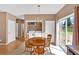 Bright dining area with back yard view near stainless steel kitchen appliances and an adjacent laundry area at 200 Arrowhead Ln, Canton, GA 30114