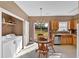 Bright dining area with backyard view, next to stainless steel kitchen appliances and a convenient laundry area at 200 Arrowhead Ln, Canton, GA 30114