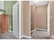 Hallway with neutral walls, carpeted floor, and a view into a room with green accent wall at 200 Arrowhead Ln, Canton, GA 30114