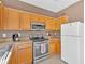 Galley kitchen features stainless steel appliances, light countertops, and wood cabinets at 200 Arrowhead Ln, Canton, GA 30114