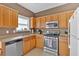 Bright kitchen with stainless steel appliances, light countertops, and wood cabinets offers a practical cooking space at 200 Arrowhead Ln, Canton, GA 30114