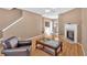 Cozy living room featuring a fireplace, wood-look floors, with an adjacent laundry and dining area at 200 Arrowhead Ln, Canton, GA 30114