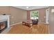 Comfortable living room boasting wood-look floors, natural light, and a charming fireplace at 200 Arrowhead Ln, Canton, GA 30114