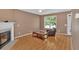 Comfortable living room boasting wood-look floors, natural light, and a charming fireplace at 200 Arrowhead Ln, Canton, GA 30114