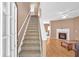 Inviting foyer with carpeted staircase leading upstairs adjacent to a living room featuring fireplace and wood floors at 200 Arrowhead Ln, Canton, GA 30114
