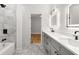 Bright bathroom with double vanity, recessed lighting, and a glimpse of the bedroom at 221 Silver Springs Sw Cir, Atlanta, GA 30310