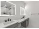 Contemporary bathroom with dual sinks, backlit mirrors, and quartz countertops at 221 Silver Springs Sw Cir, Atlanta, GA 30310