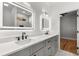 Luxurious bathroom with double sink vanity, lighted mirrors, and marble tile at 221 Silver Springs Sw Cir, Atlanta, GA 30310