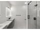 Modern bathroom featuring double vanity and tiled shower with glass enclosure at 221 Silver Springs Sw Cir, Atlanta, GA 30310