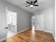 Spacious bedroom featuring hardwood floors, ceiling fan, and ensuite bathroom at 221 Silver Springs Sw Cir, Atlanta, GA 30310