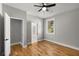 Cozy bedroom featuring hardwood floors, closet, and view of ensuite bathroom at 221 Silver Springs Sw Cir, Atlanta, GA 30310