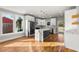 Modern kitchen with white cabinets, stainless steel appliances, a marble island, and hardwood floors at 221 Silver Springs Sw Cir, Atlanta, GA 30310