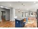 This modern kitchen has a blue island with a white marble countertop and stainless steel appliances at 221 Silver Springs Sw Cir, Atlanta, GA 30310
