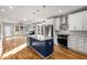 Open concept kitchen with a blue island, stainless steel appliances, and hardwood floors at 221 Silver Springs Sw Cir, Atlanta, GA 30310