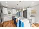 Bright kitchen features an island with a marble countertop, pendant lighting, and white cabinets at 221 Silver Springs Sw Cir, Atlanta, GA 30310