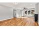 Open living room is bright with hardwood floors, modern fan, and large windows framing the outside views at 221 Silver Springs Sw Cir, Atlanta, GA 30310