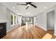 Light-filled open-concept living room features hardwood floors, and a modern ceiling fan with a seamless flow to the kitchen at 221 Silver Springs Sw Cir, Atlanta, GA 30310