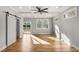 Large main bedroom features hardwood floors, a coffered ceiling, and sliding barn door at 221 Silver Springs Sw Cir, Atlanta, GA 30310