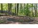 Image of a pool area covered with a net surrounded by red bricks and a fenced yard at 3200 Country Club Nw Ct, Kennesaw, GA 30144
