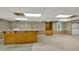 Basement with bar area, built-in shelving, neutral carpet, and large window at 3200 Country Club Nw Ct, Kennesaw, GA 30144