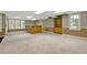 Spacious basement with bar area, built-in shelving, and multiple windows at 3200 Country Club Nw Ct, Kennesaw, GA 30144