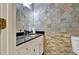 Bathroom features stone wall, granite sink, and white toilet at 3200 Country Club Nw Ct, Kennesaw, GA 30144