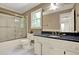 Bathroom features a tub and shower combo, and white vanity with black countertop at 3200 Country Club Nw Ct, Kennesaw, GA 30144