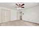 Bedroom features ceiling fan and closet, with an open doorway to a hallway at 3200 Country Club Nw Ct, Kennesaw, GA 30144