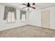 Bright bedroom with ceiling fan, shutters on two windows, and neutral carpet at 3200 Country Club Nw Ct, Kennesaw, GA 30144
