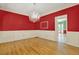 Elegant dining room boasting hardwood floors, wainscoting, and a sparkling chandelier at 3200 Country Club Nw Ct, Kennesaw, GA 30144