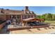 A beautiful exterior elevation of a brick home with an outdoor seating area and a golf course at 3200 Country Club Nw Ct, Kennesaw, GA 30144