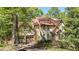 Two-story home featuring an attached two-car garage and landscaped yard with mature trees at 3200 Country Club Nw Ct, Kennesaw, GA 30144
