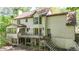 View of the home's rear elevation and elevated deck with wrought iron railings at 3200 Country Club Nw Ct, Kennesaw, GA 30144