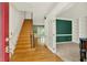 Inviting foyer with hardwood floors, a staircase, and an adjacent room with elegant French doors at 3200 Country Club Nw Ct, Kennesaw, GA 30144
