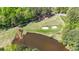 Overhead view of a well-manicured golf course with sand traps and a small pond at 3200 Country Club Nw Ct, Kennesaw, GA 30144