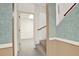 Hallway with view into room and stairs with half wall and wooden handrail at 3200 Country Club Nw Ct, Kennesaw, GA 30144